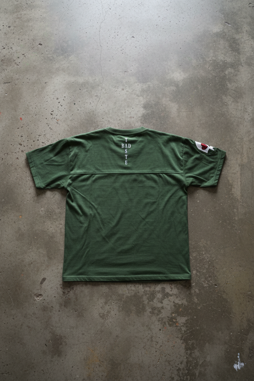 BADTASTE Green Tee Back on Concrete